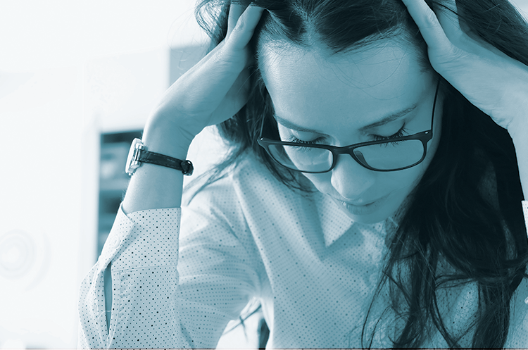 Kvinde holder hænderne på hovedet, lukkede øjne